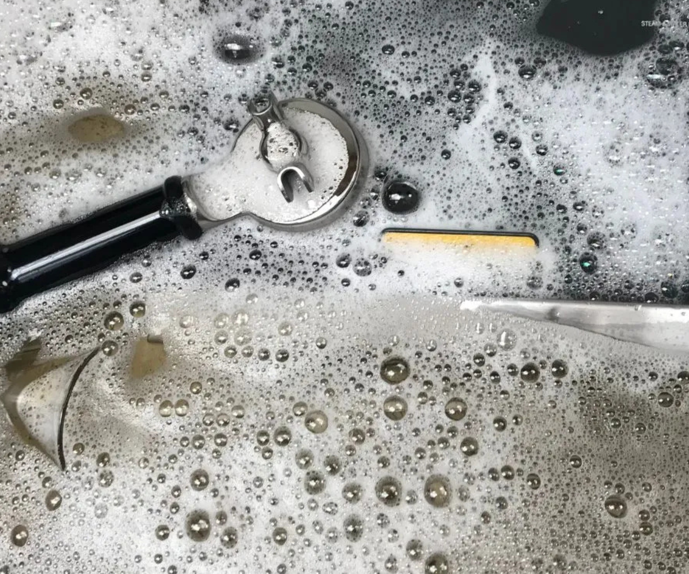 Parts of the casabrews 5700 pro in a soapy sink