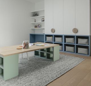 desk with seafoam green legs in a playroom with soft blue millwork