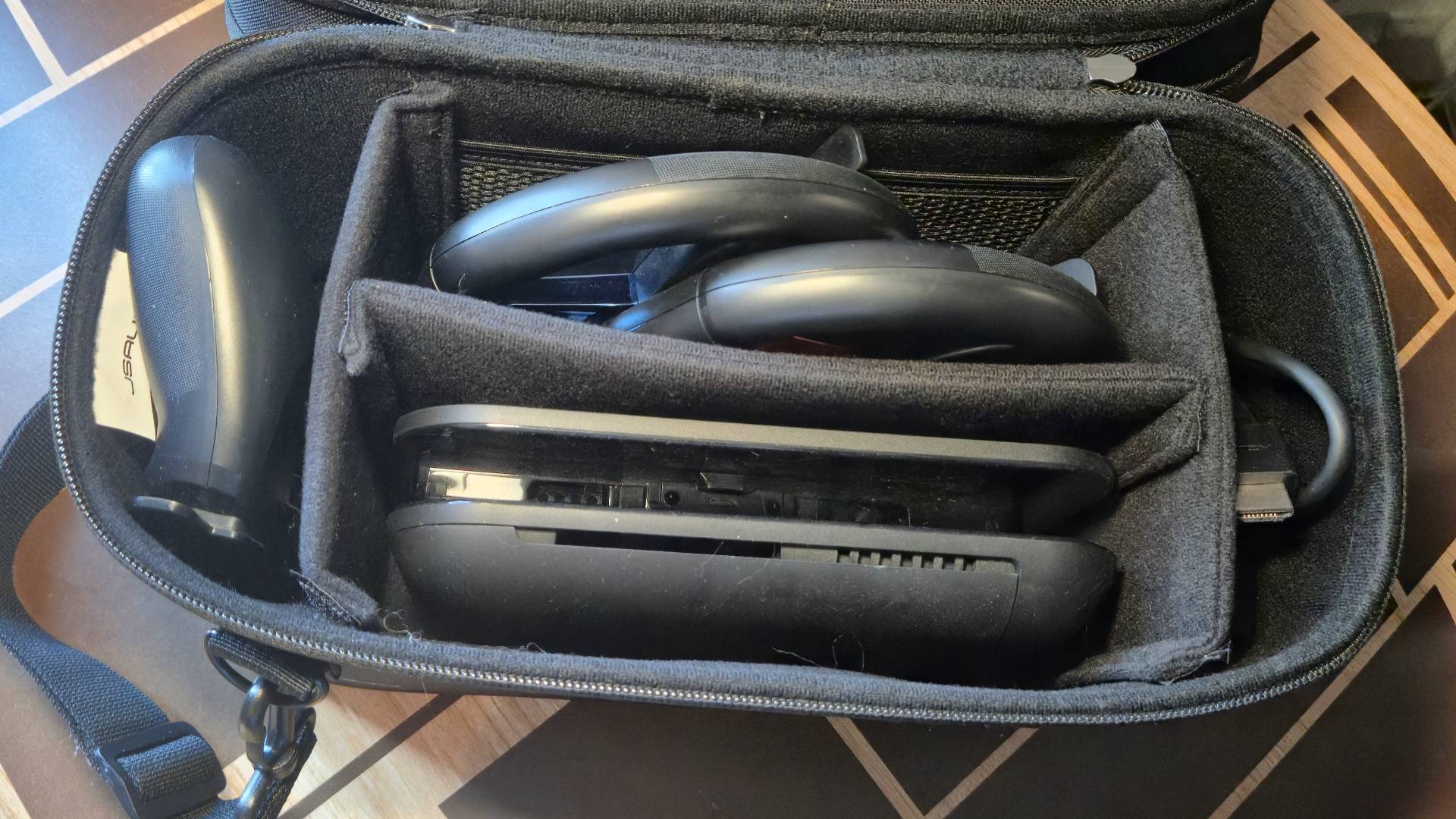 Photo of the inside of a case Switch 2 case showing the Switch 2 dock and other accessories.