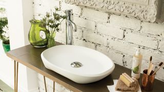 counter top basin with exposed brick splashback