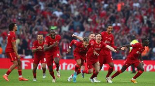 Liverpool players celebrate beating Chelsea on penalties in the FA Cup final.