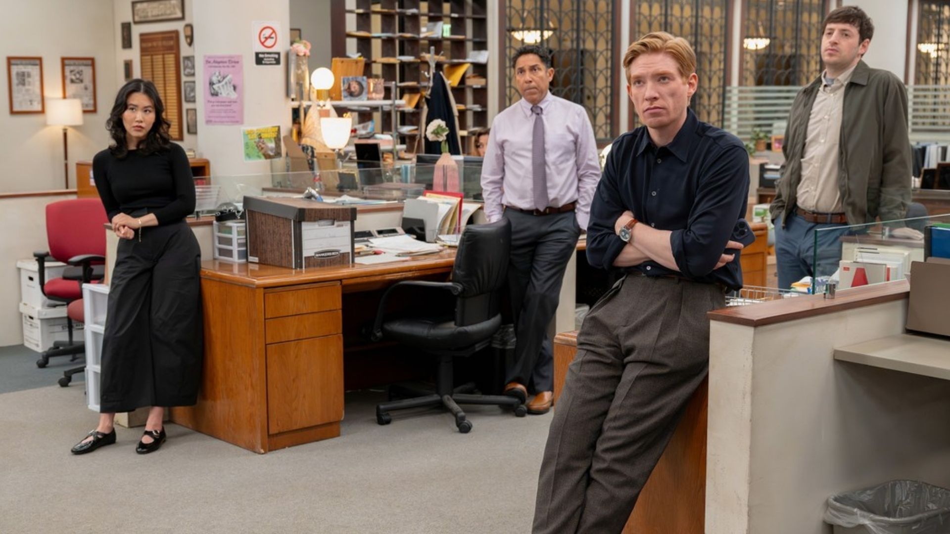 Ned, Nicole, Oscar and Adam lean up against office furniture