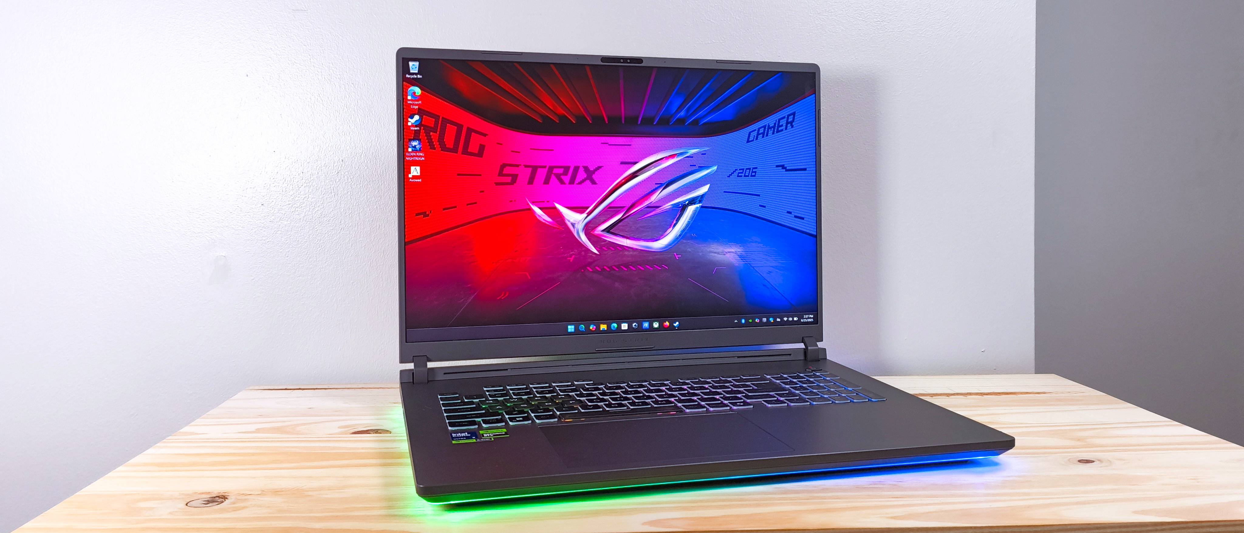 The Asus ROG Strix G18 with lid open on a wood table