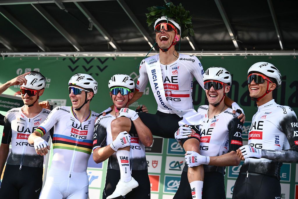 UAE Team Emirates&rsquo;s Polish rider Rafal Majka (C) is hoisted up by teammates as he celebrates his last race, ahead of the 119th edition of the Giro di Lombardia (Tour of Lombardy), a 238km cycling race from Como to Bergamo on October 11, 2025. (Photo by Marco BERTORELLO / AFP)