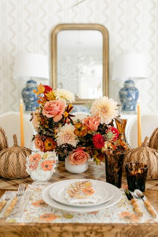 fall table with rattan pumpkins, flowers and tortoiseshell glassware