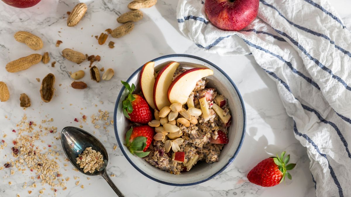 bowl of oatmeal topped with apple