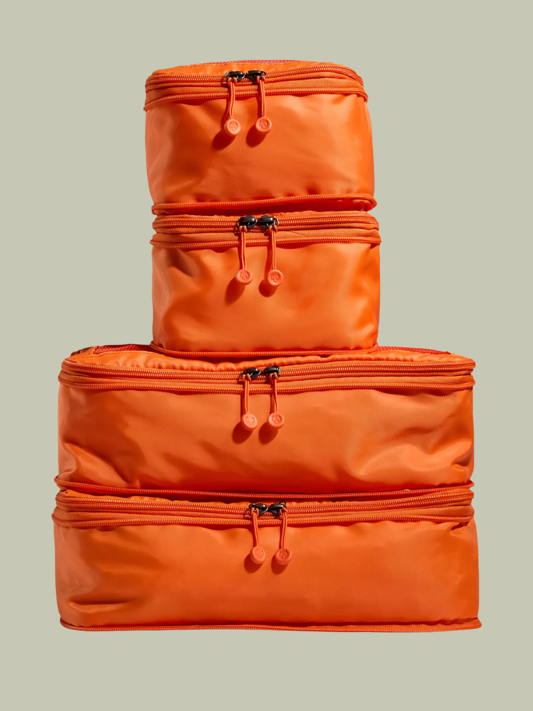 A set of four orange woven packing cubes from Antler