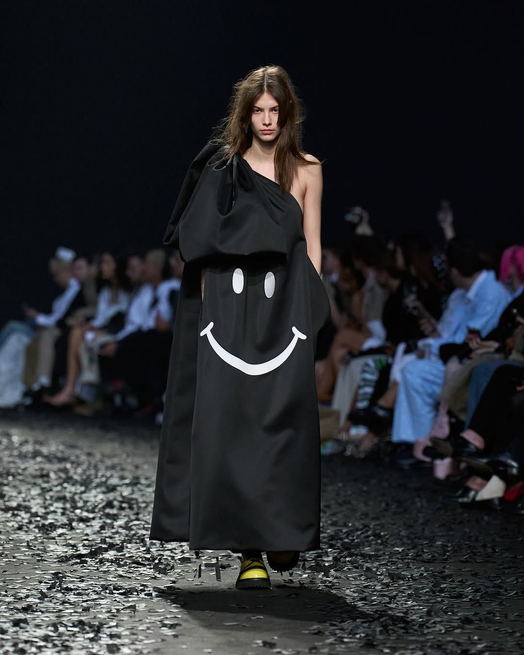 Moschino model wears black dress on runway