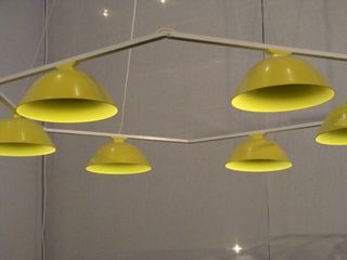 Yellow pendant lamps hanging from a hexagon