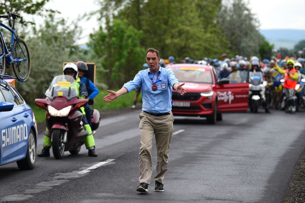 NYIREGYHAZA HUNGARY MAY 13 Bruno Valcic of Croatia UCI commissarie restarts the race while the peloton stopped due to a train crossing during the 43rd Tour de Hongrie 2022 Stage 3 a 154km stage from Sarospatak to Nyiregyhaza tourdehongrie on May 13 2022 in Nyiregyhaza Hungary Photo by Dario BelingheriGetty Images