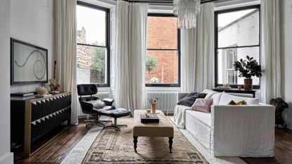 Apartment living room with plaster pink walls and white sofa