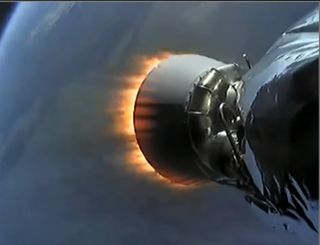 A shortened SpaceX Falcon 9 rocket upper stage engine fires in space during a launch