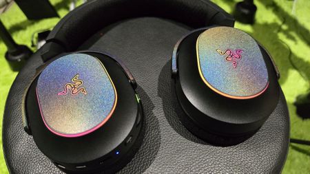 The Razer Barracuda X Chroma wireless gaming headset with a colorful finish on a chair.