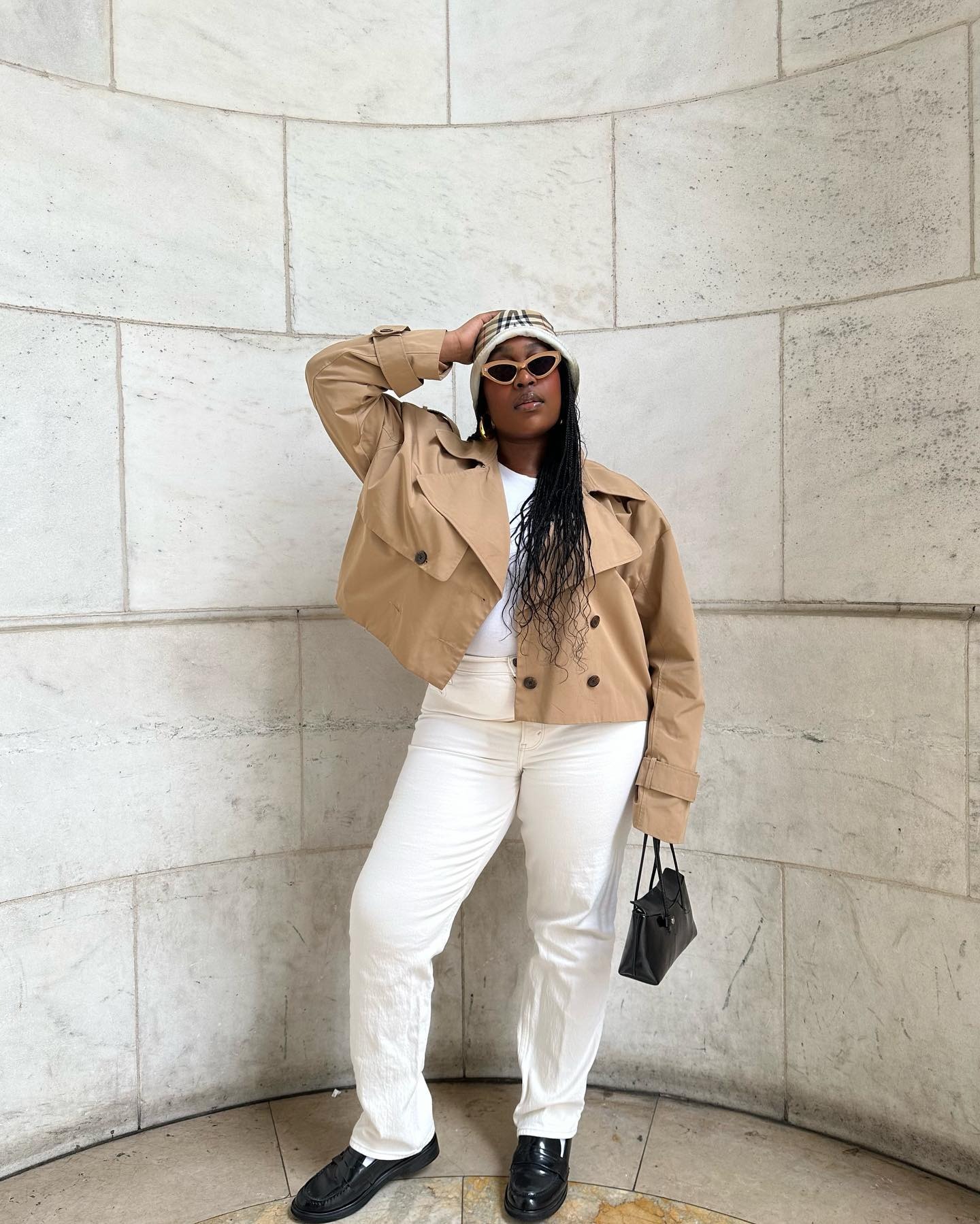 Woman wearing a cropped trench coat outfit idea.