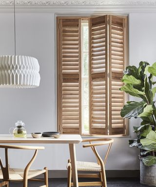 wooden window shutters at a dining room window