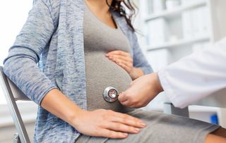 A pregnant woman getting a check-up.