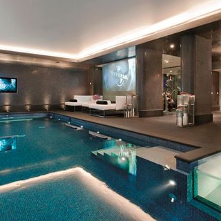 swimming pool with textured wall and white sofa