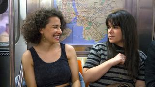 Abbi Jacobson and Ilana Glazer sit on a subway train in a still from Broad City