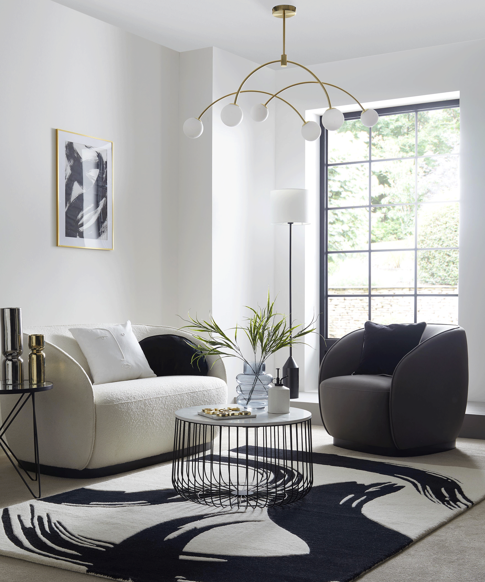A modern minimalist living room with paint stroke motif rug, curved faux leather armchair, boucle sofa