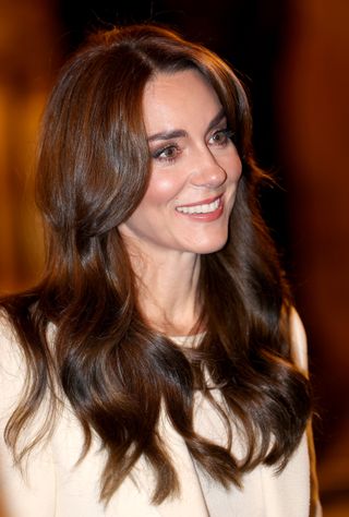 Kate Middleton with long wavy hair.