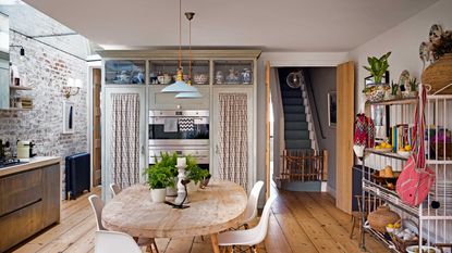 kitchen with wooden flooring and dining table with open shelving unit