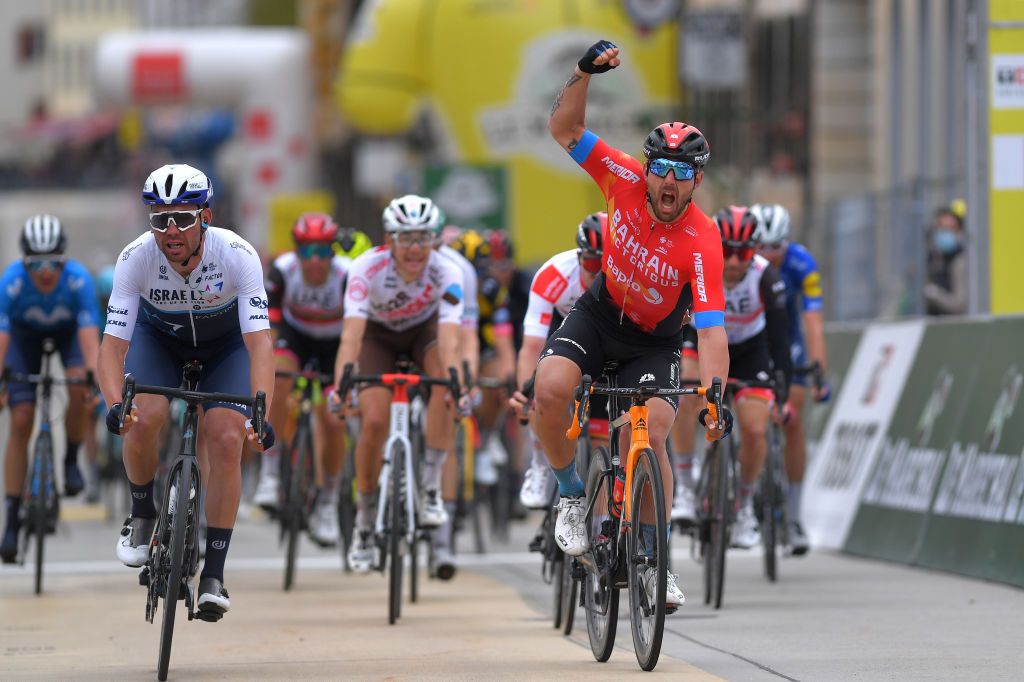 SAINTIMIER SWITZERLAND APRIL 29 Sonny Colbrelli of Italy and Team Bahrain Victorious celebrates at arrival beating Patrick Bevin of New Zealand and Team Israel StartUp Nation L at arrival during the 74th Tour De Romandie 2021 Stage 2 a 1657km stage from La Neuveville to SaintImier TDR2021 TDRnonstop UCIworldtour on April 29 2021 in SaintImier Switzerland Photo by Luc ClaessenGetty Images