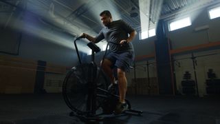 Man exercises on air bike