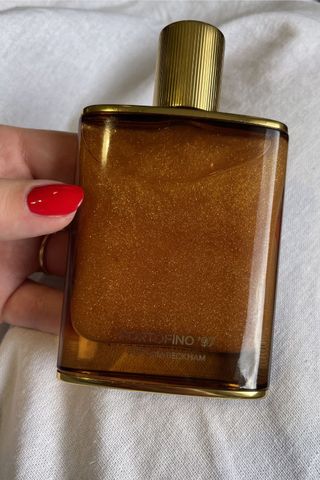 valeza holding the portofino shimmering body oil