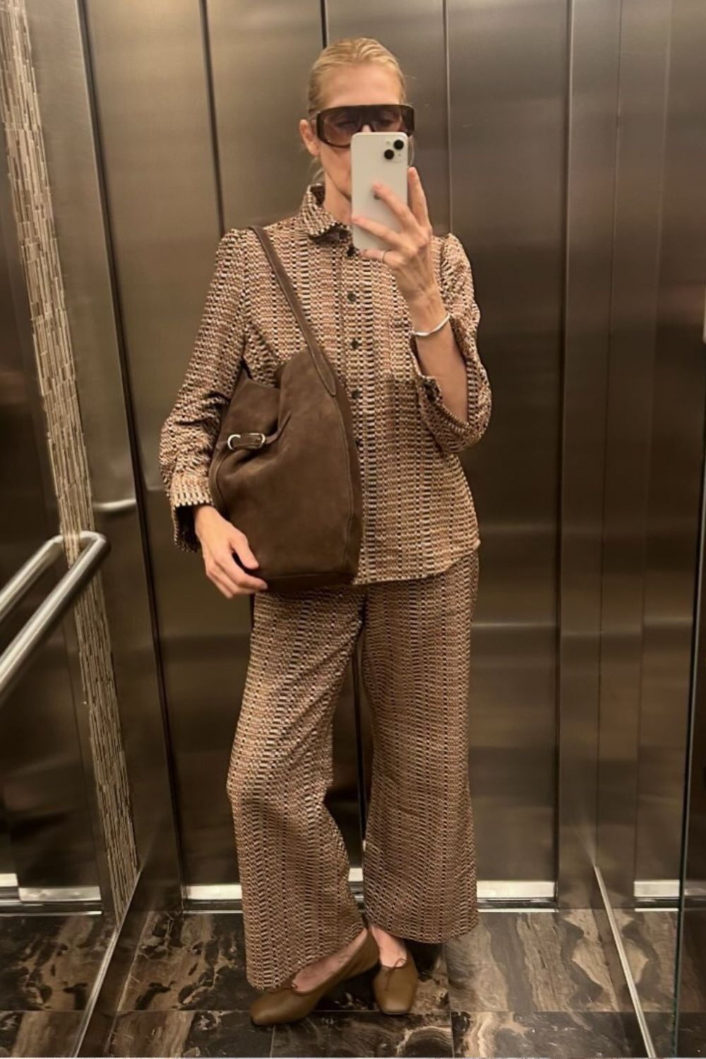 Kelly Rutherford wears a matching set, carries Liffner Belted Bucket Bag