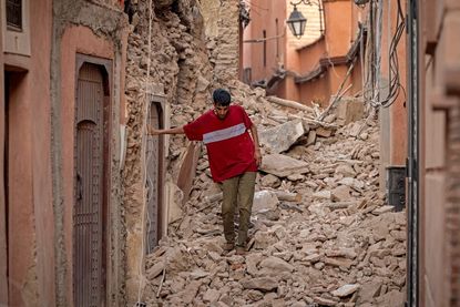 A man wades through the rubble following an earthquake in Morocco.