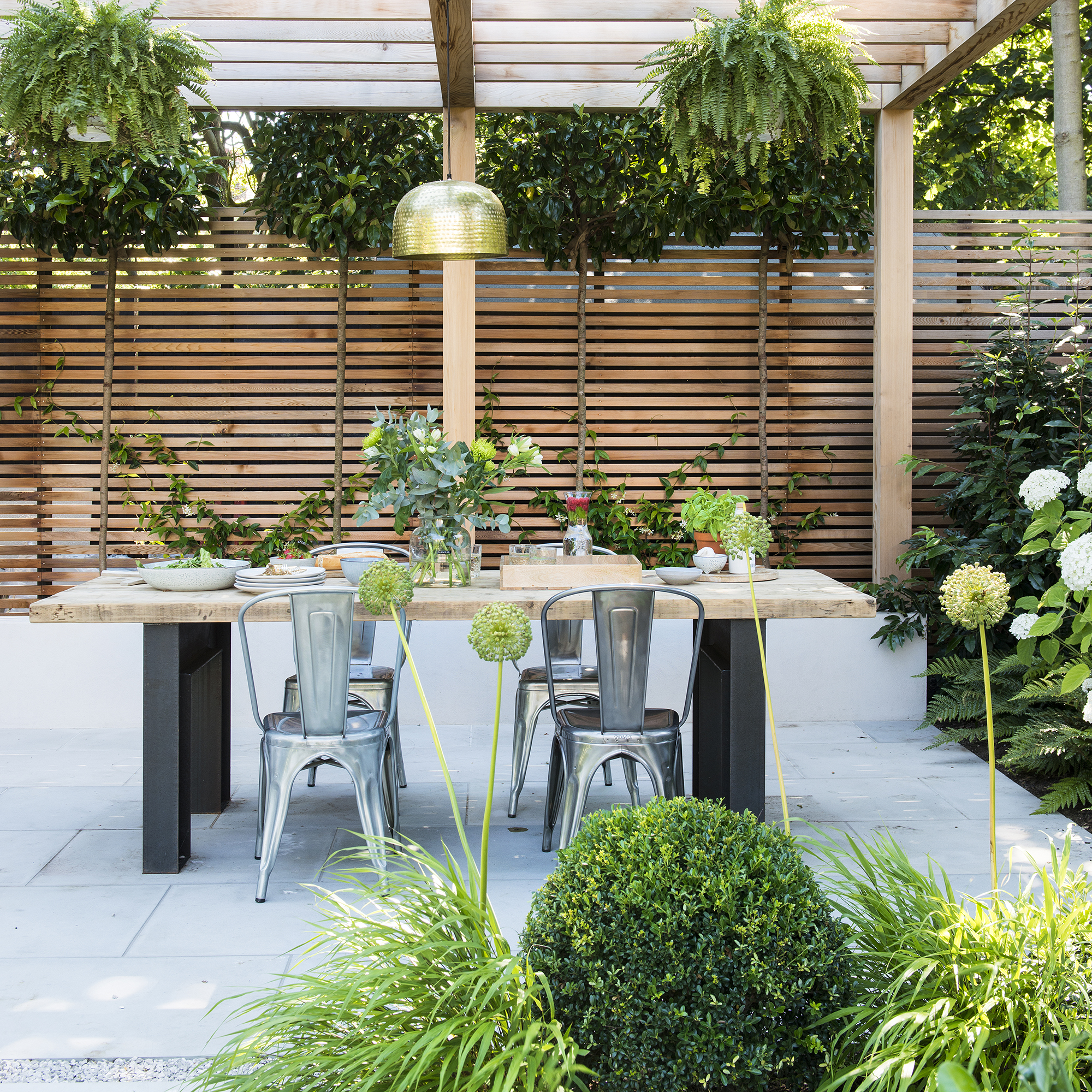 Garden with wooden panelled fencing and patio area