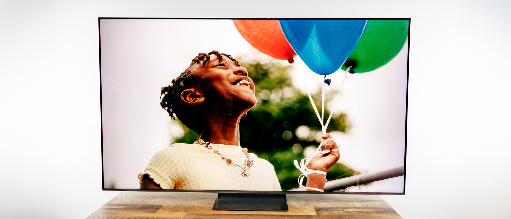 TCL QM7L 75-inch TV on a desk