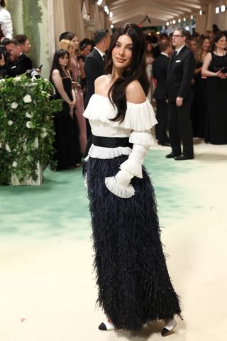 Camila morrone in a black and white gown