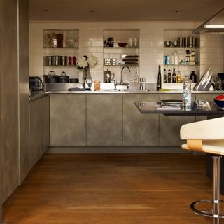 kitchen room with wooden flooring and white tiled walls
