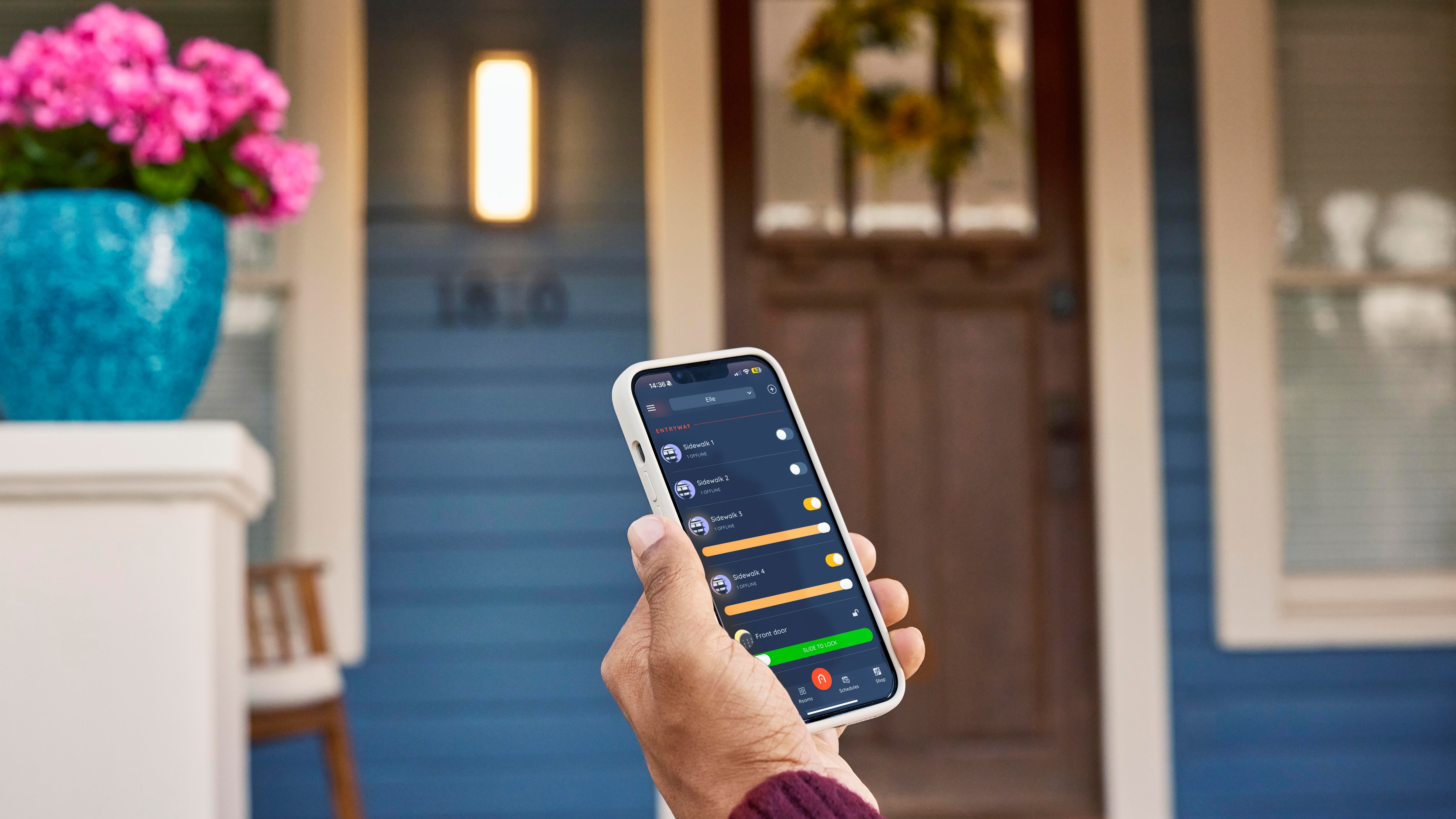Someone using the Hubspace app in front of their home.