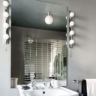 bathroom with grey wall and white wash basin