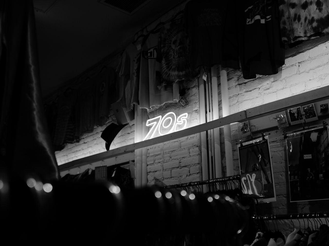 A black and white photo of a neon sign at night, shot on the Lumix L1