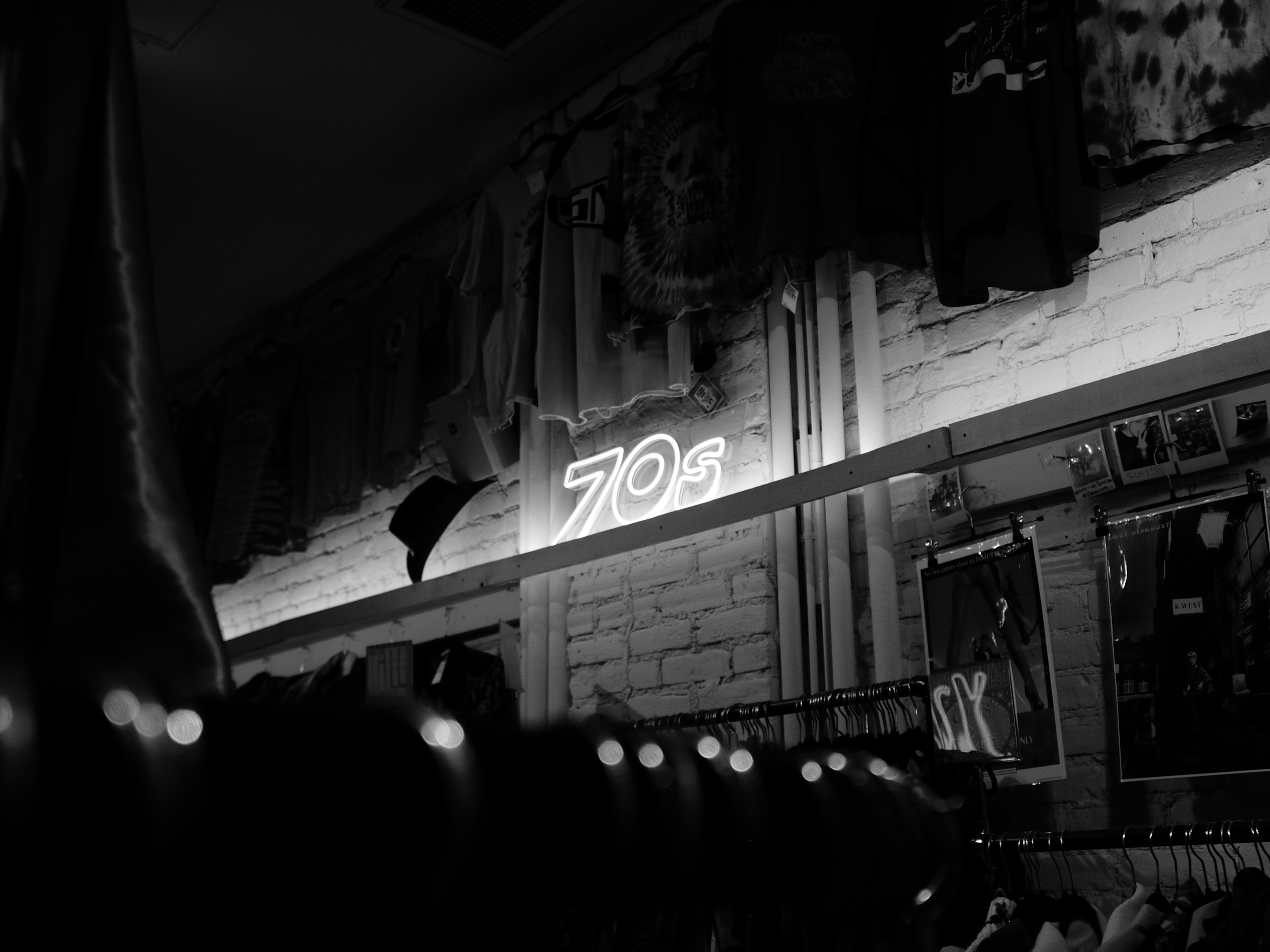 A black and white photo of a neon sign at night, shot on the Lumix L1