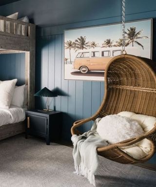 coastal bedroom with bunk beds and a egg chair