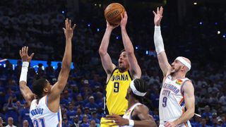 T.J. McConnell #9 of the Indiana Pacers attempts a jump shot against Alex Caruso #9 and Aaron Wiggins #21 of the Oklahoma City Thunder