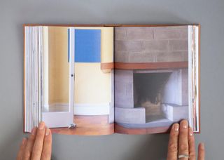 Henry Kulka book held open, showing image of Penrose House interior