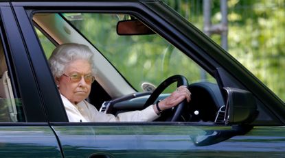 Queen Elizabeth II seen driving her Range Rover car as she watches the International Carriage Driving Grand Prix event on day 4 of the Royal Windsor Horse Show at Home Park on May 17, 2014 in Windsor, England. 