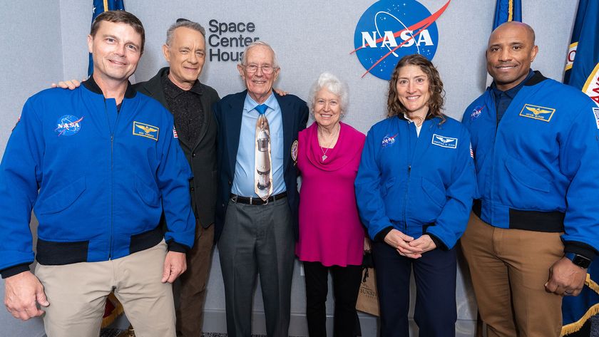 Tom Hanks joins Apollo and Artemis astronauts for a photo at Space Center Houston