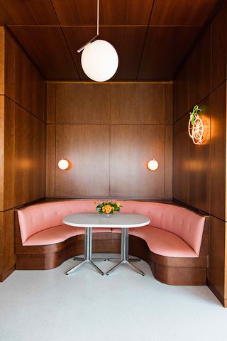 Wooden paneling and Melon leather banquette seating
