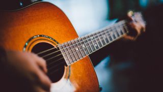 A man plays acoustic guitar