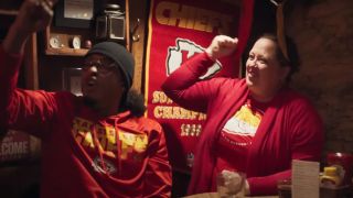 Kansas City Chiefs fans cheer in a bar for "Falling for Football," the team's 2024 commercial with Hallmark.