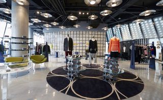 Interior with coloured-glass wall at the back of the menswear floor is the shoe boutique