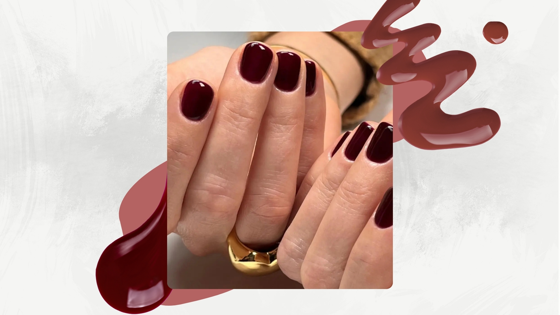 A close-up of hands with dark burgundy nails by manicurist, Julia Diogo(@paintedbyjools), featured in a white and grey template with dark pink dots and two burgundy nail polish spills
