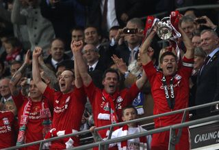 Liverpool’s captain Steven Gerrard lifts the Carling Cup, the first trophy under American ownership