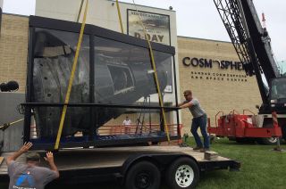 Workers load astronaut Gus Grissom's Mercury capsule, Liberty Bell 7, on a truck outside the Kansas Cosmosphere to launch the spacecraft on its journey to Germany, June 18, 2014.